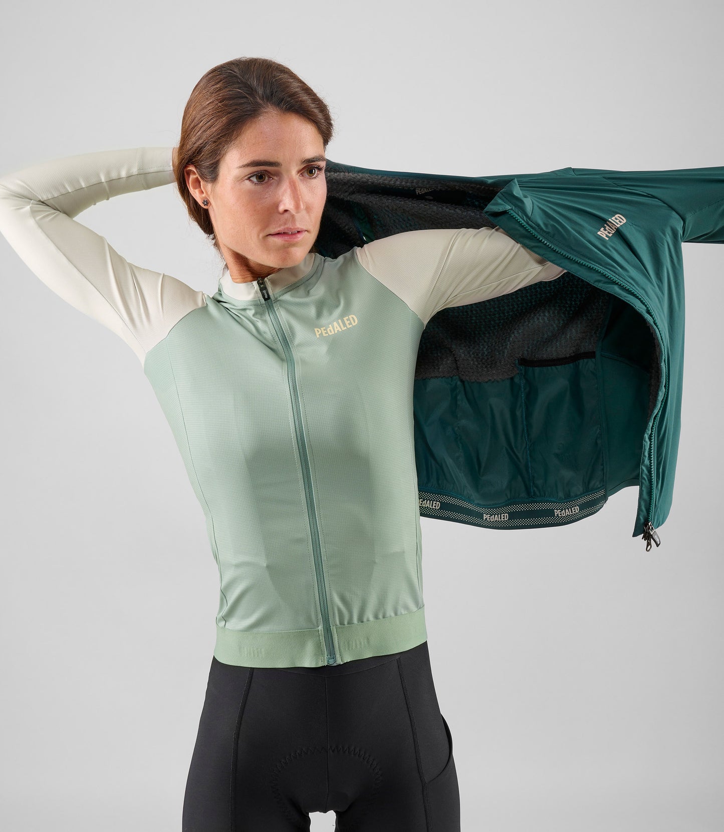 W5WAJEL18PE_11_women cycling jacket alpha teal element wearing left pedaled