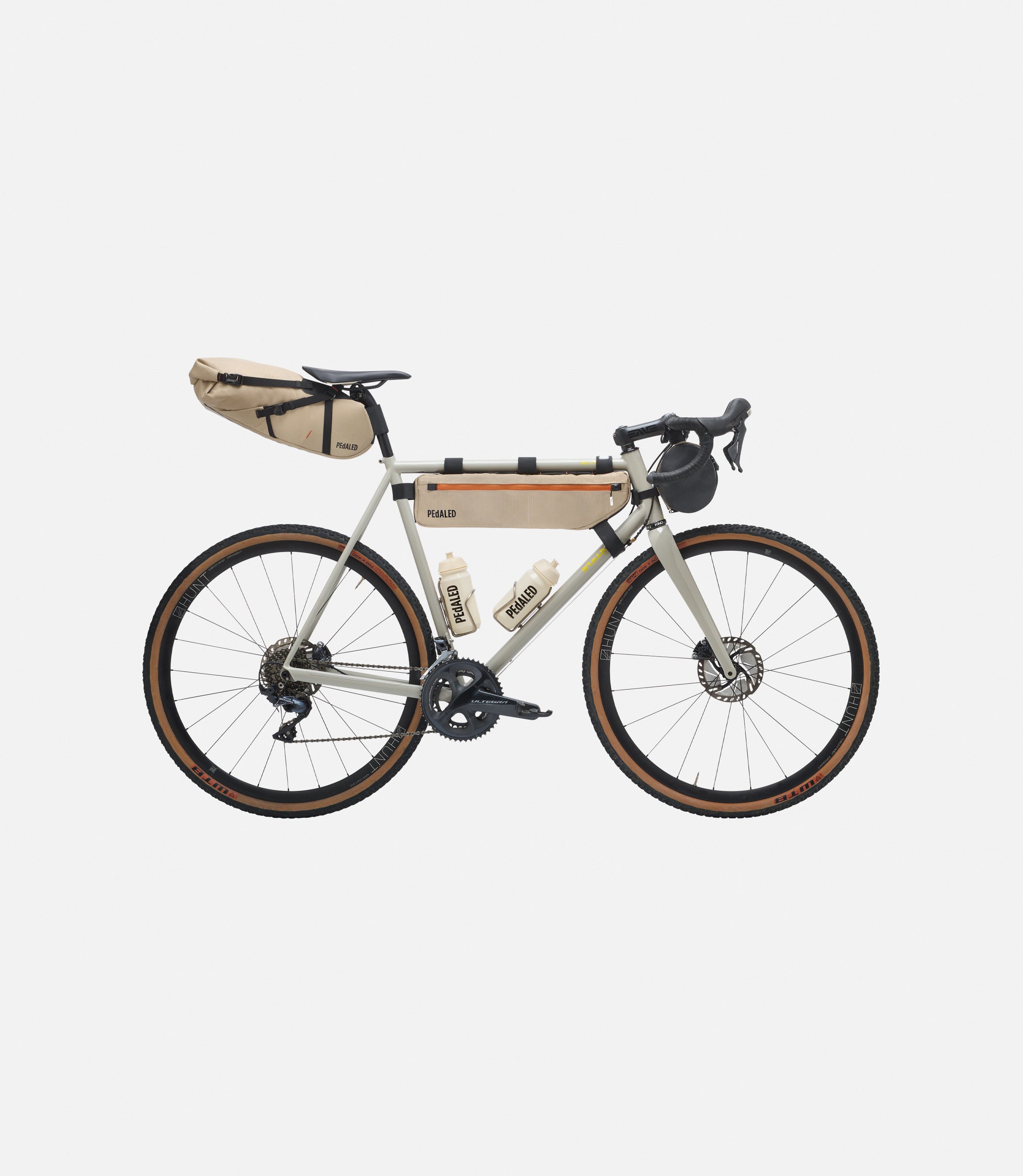 234FBOD56PE_2_bikepacking bag complete kit desert front pedaled 1