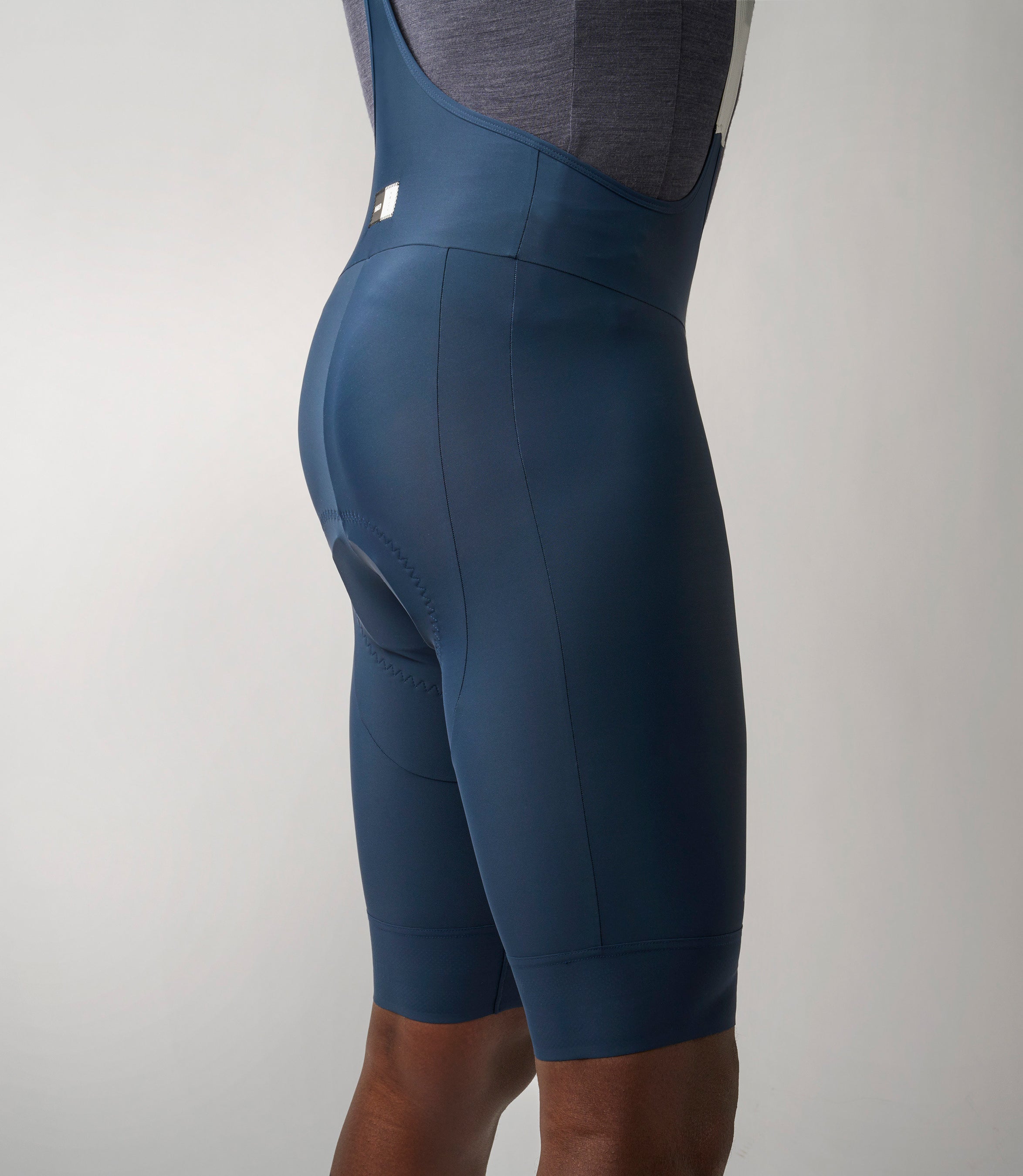 23SBBES74PE_7_cycling bibshorts men essential navy side pedaled