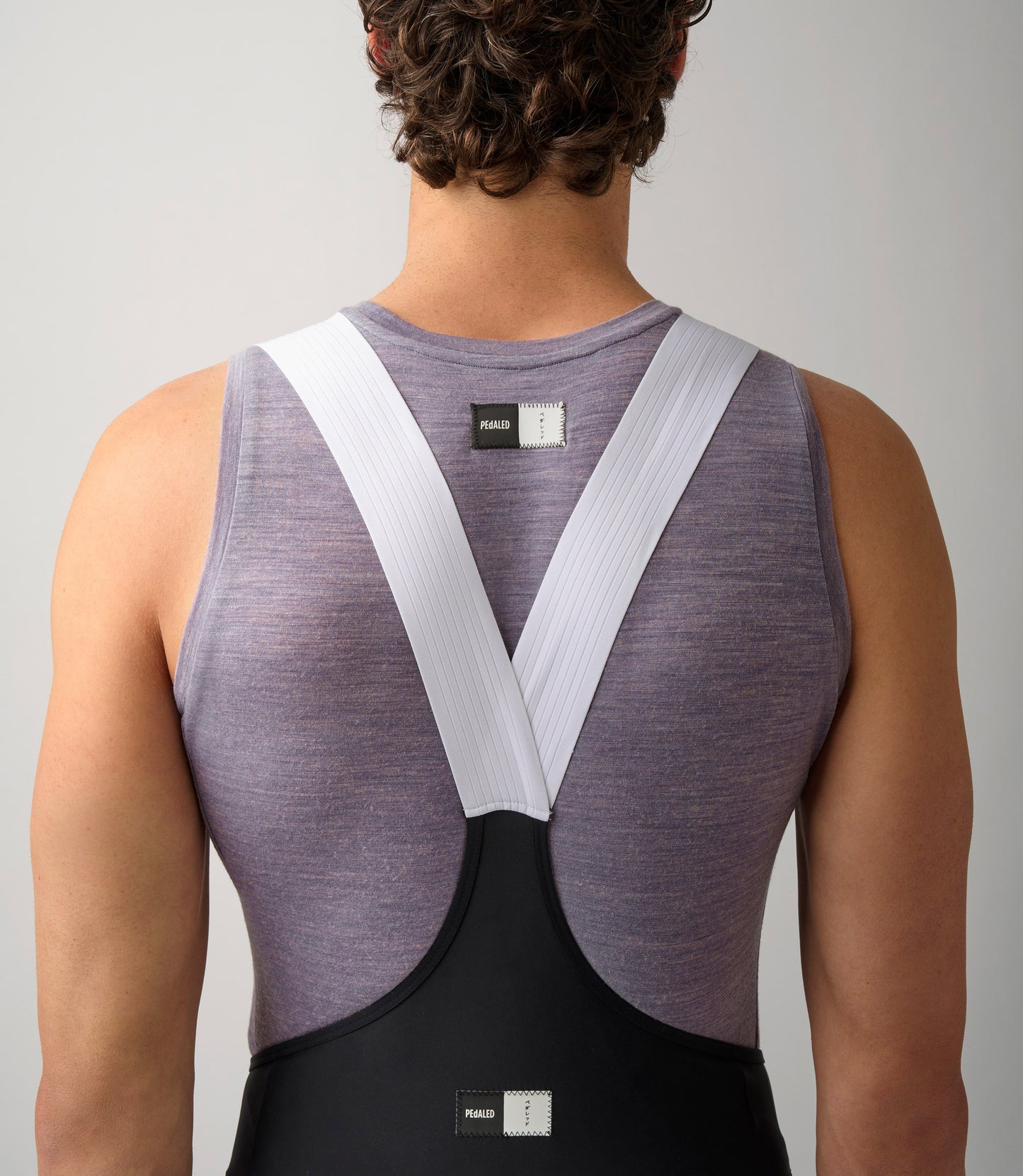 23SBLEM0IPE_6_men cycling merino base layer lilac essential back logo pedaled