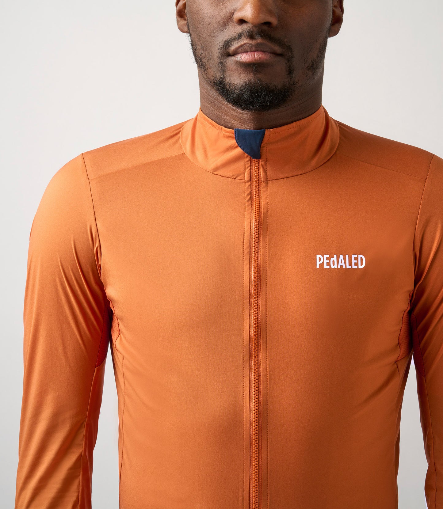 23SJKES0HPE_5_cycling windproof jacket men orange essential front pedaled