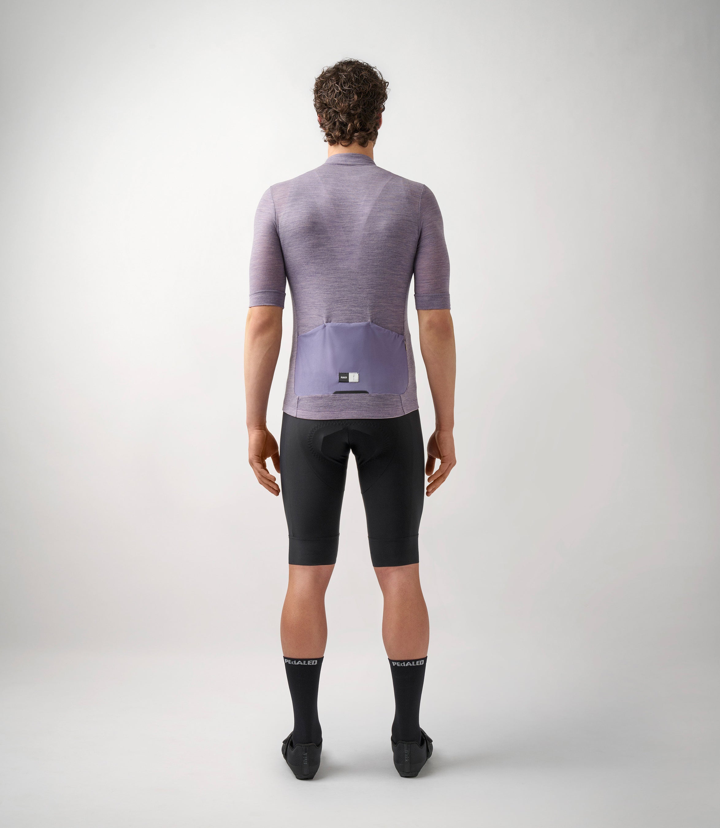 23SJSEM0IPE_4_men cycling merino jersey lilac essential total body back pedaled