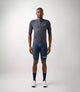 23SJSEM74PE_3_men cycling merino jersey navy essential total body front pedaled