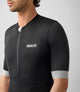 23SJSES00PE_8_cycling jersey men black essential front pedaled