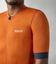 23SJSES0HPE_6_cycling jersey men orange essential front pedaled