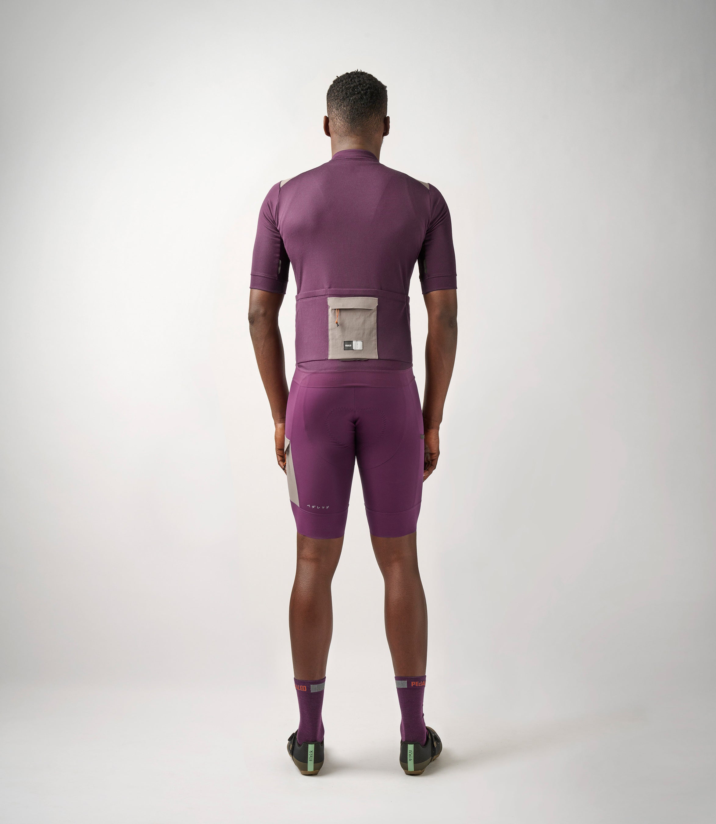 23SMJOD10PE_4_men cycling merino jersey purple odyssey total body back pedaled