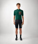 23SMJOD78PE_3_men cycling merino jersey green odyssey total body front pedaled