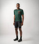 23SMTOD78PE_3_men cycling merino tee green odyssey total body front pedaled