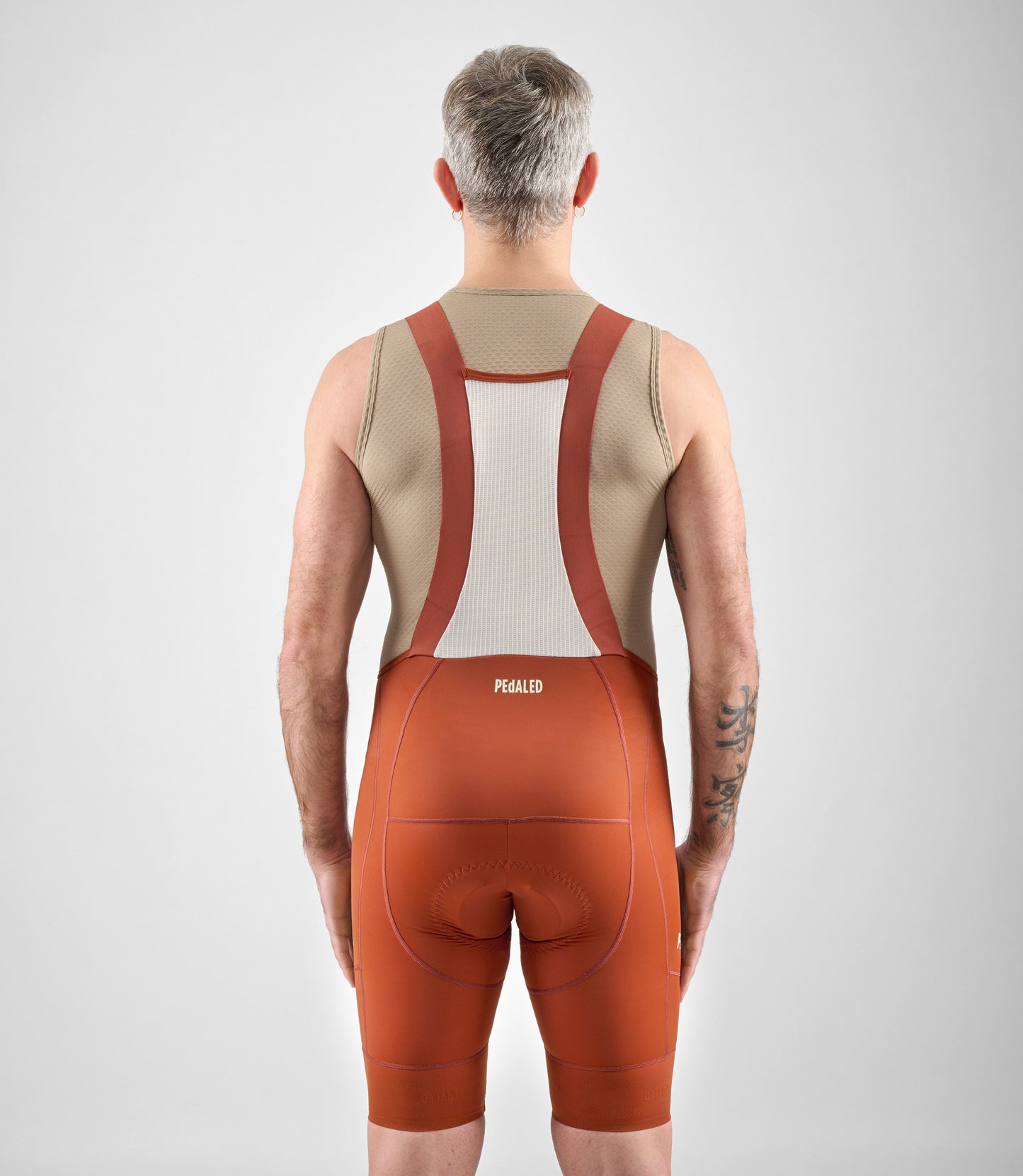 24SBBEL0QPE_4_men cycling bibshorts element brick red total body back pedaled