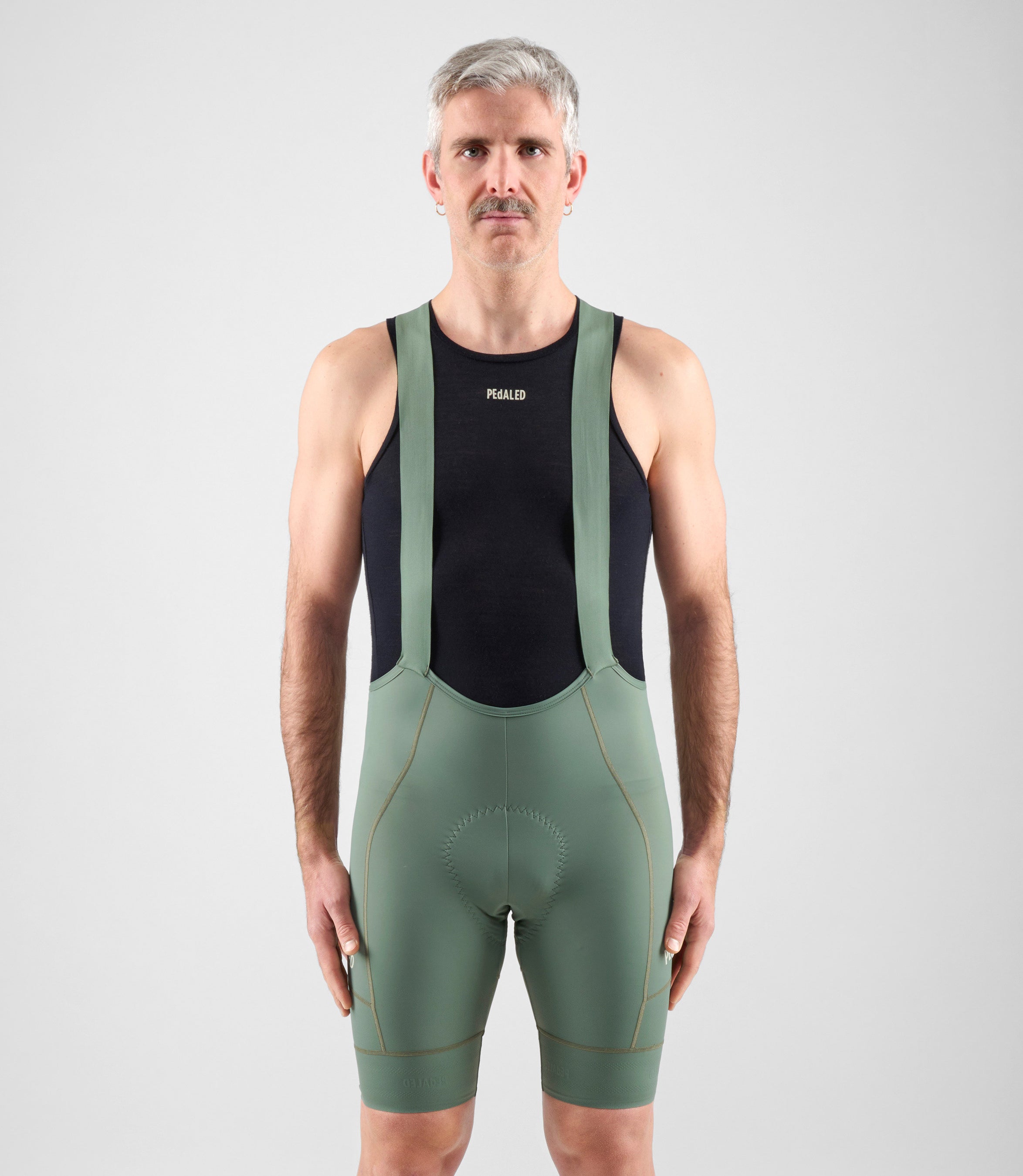 24SBBEL11PE_3_men cycling bibshorts element green total body front pedaled