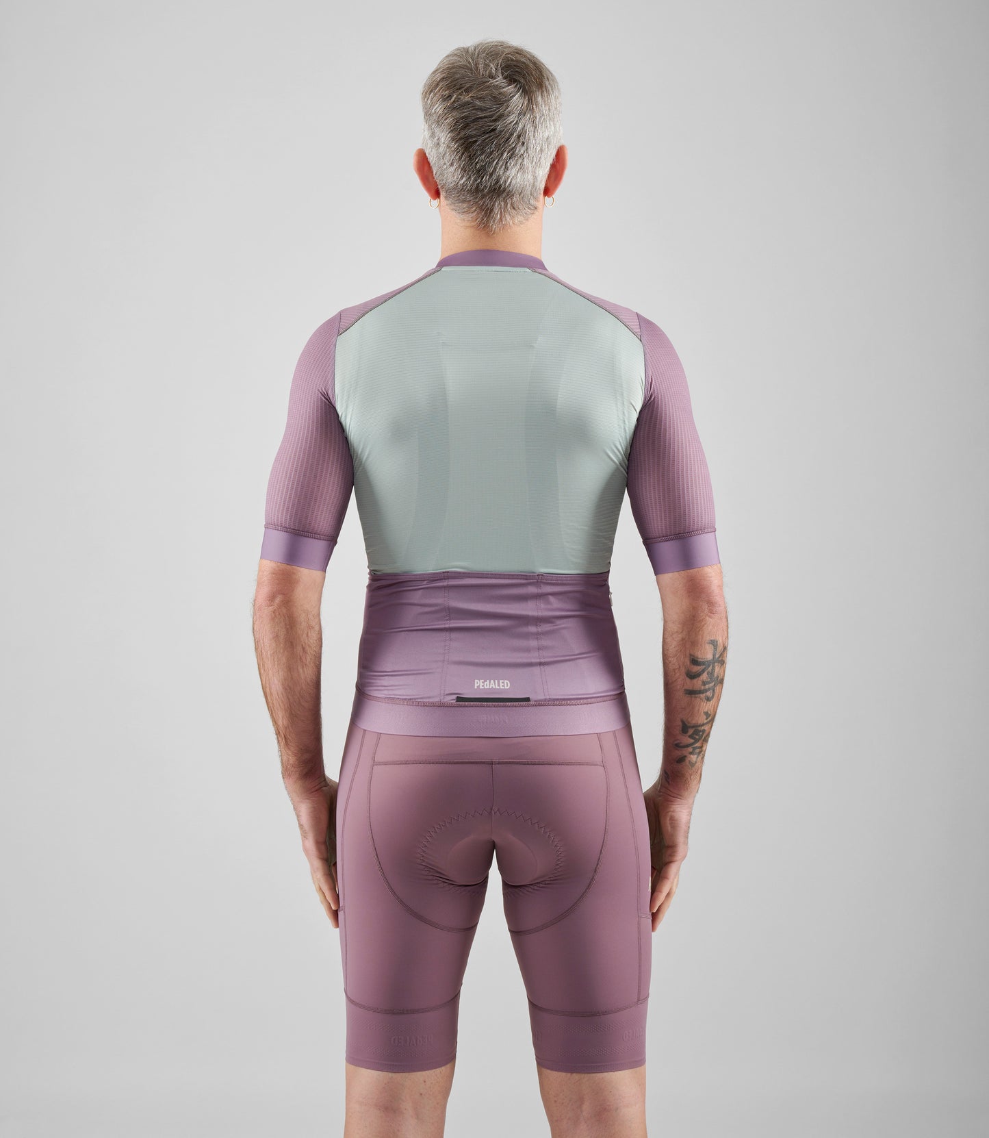 24SJSEL0IPE_4_men cycling jersey element lilac total body back pedaled