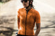 W1SJSMI12PE_3_women cycling jersey road orange mirai in action pedaled