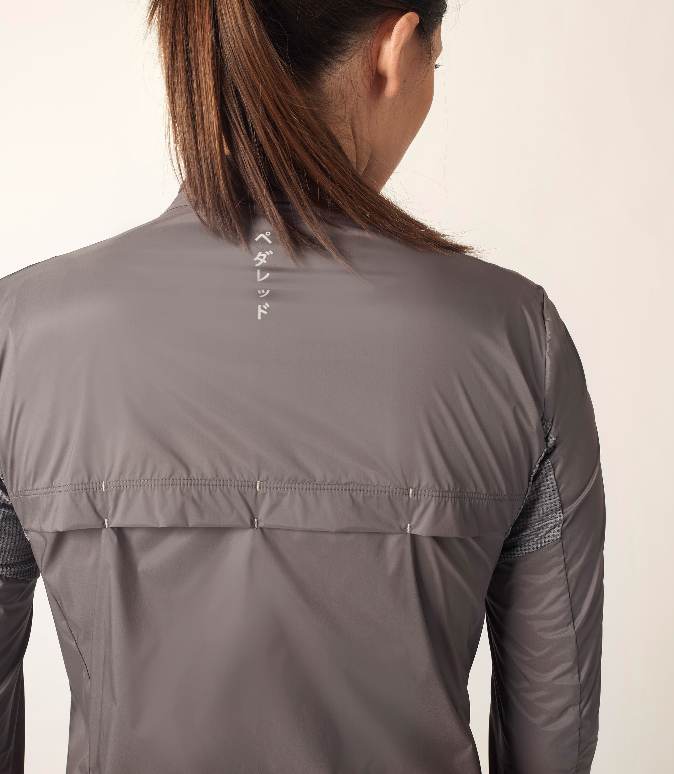 W2SJKMI70PE_7_woman cycling jacket grey mirai back pedaled