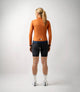 W3SJKES0HPE_4_women cycling windproof jacket orange essential total body back pedaled