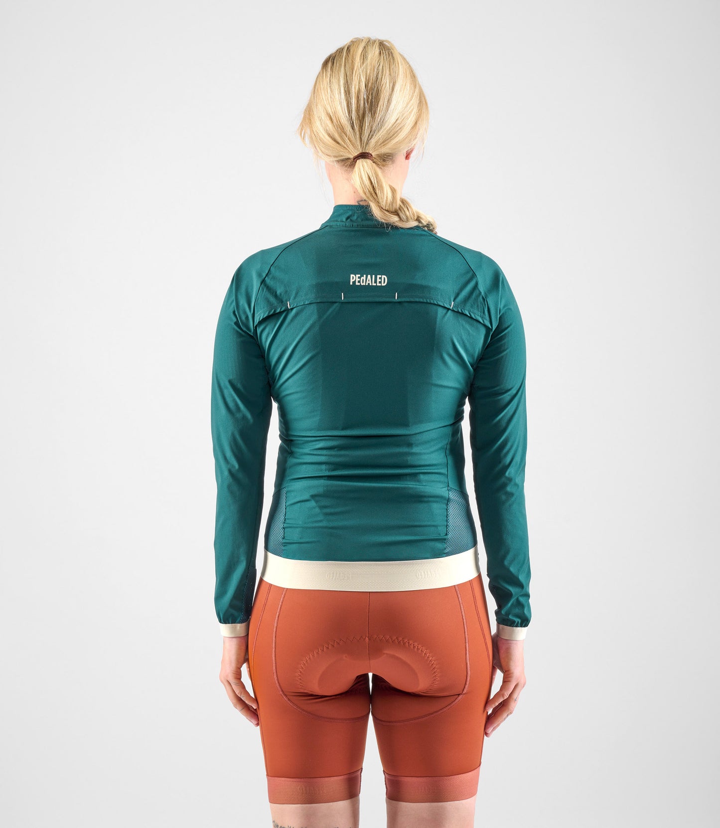 W4SJKEL18PE_4_women cycling windproof jacket light teal element total body back pedaled